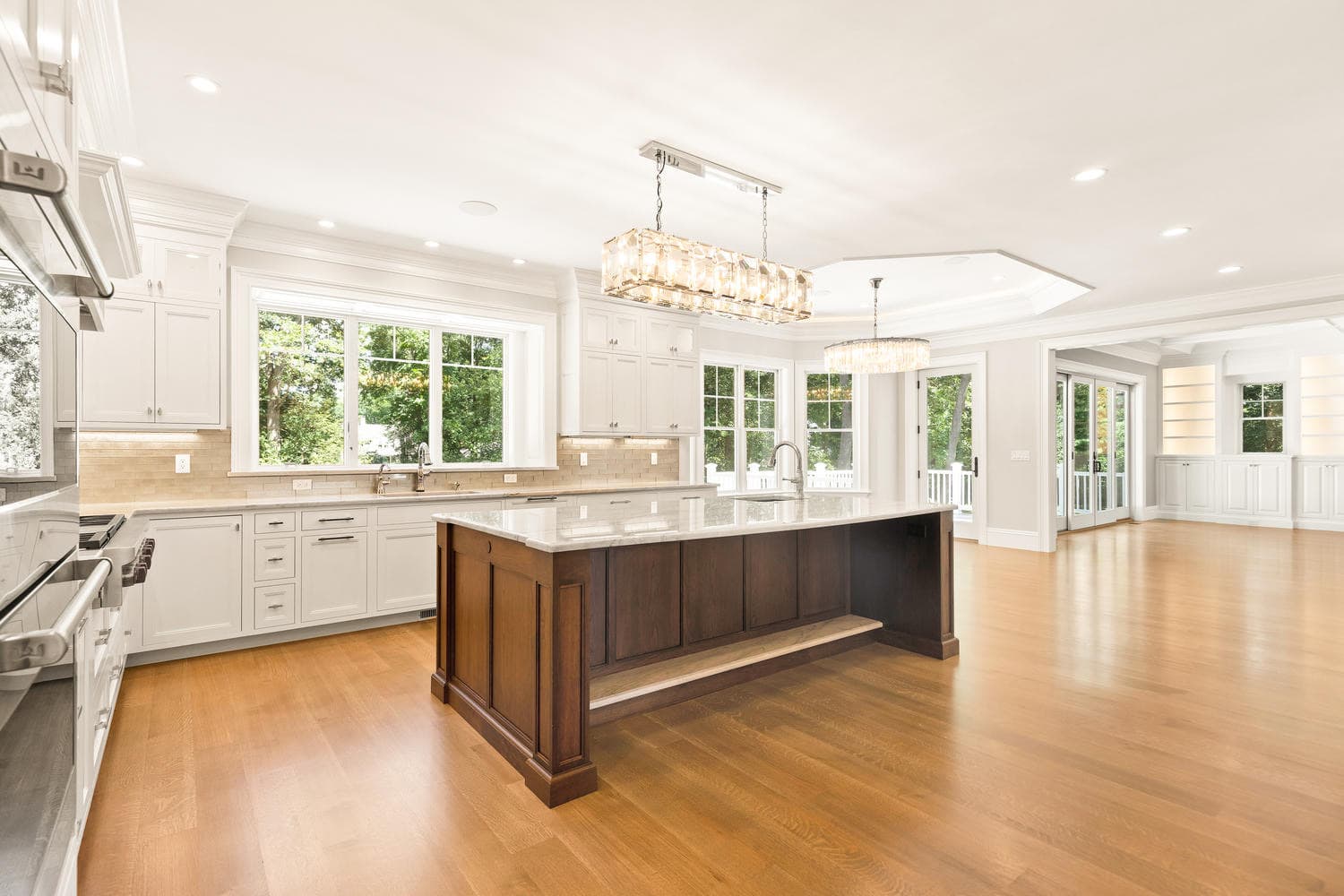 Family room coffered ceiling detail with lighted built-in shelving and butler's pantry beyond