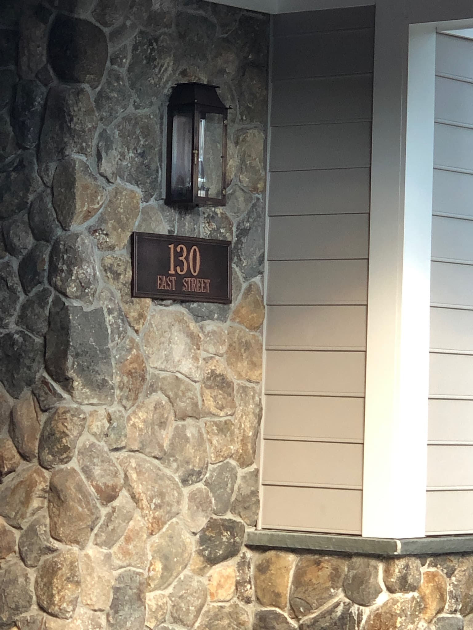 Stone entry column with 130 East Street house plaque and copper lantern