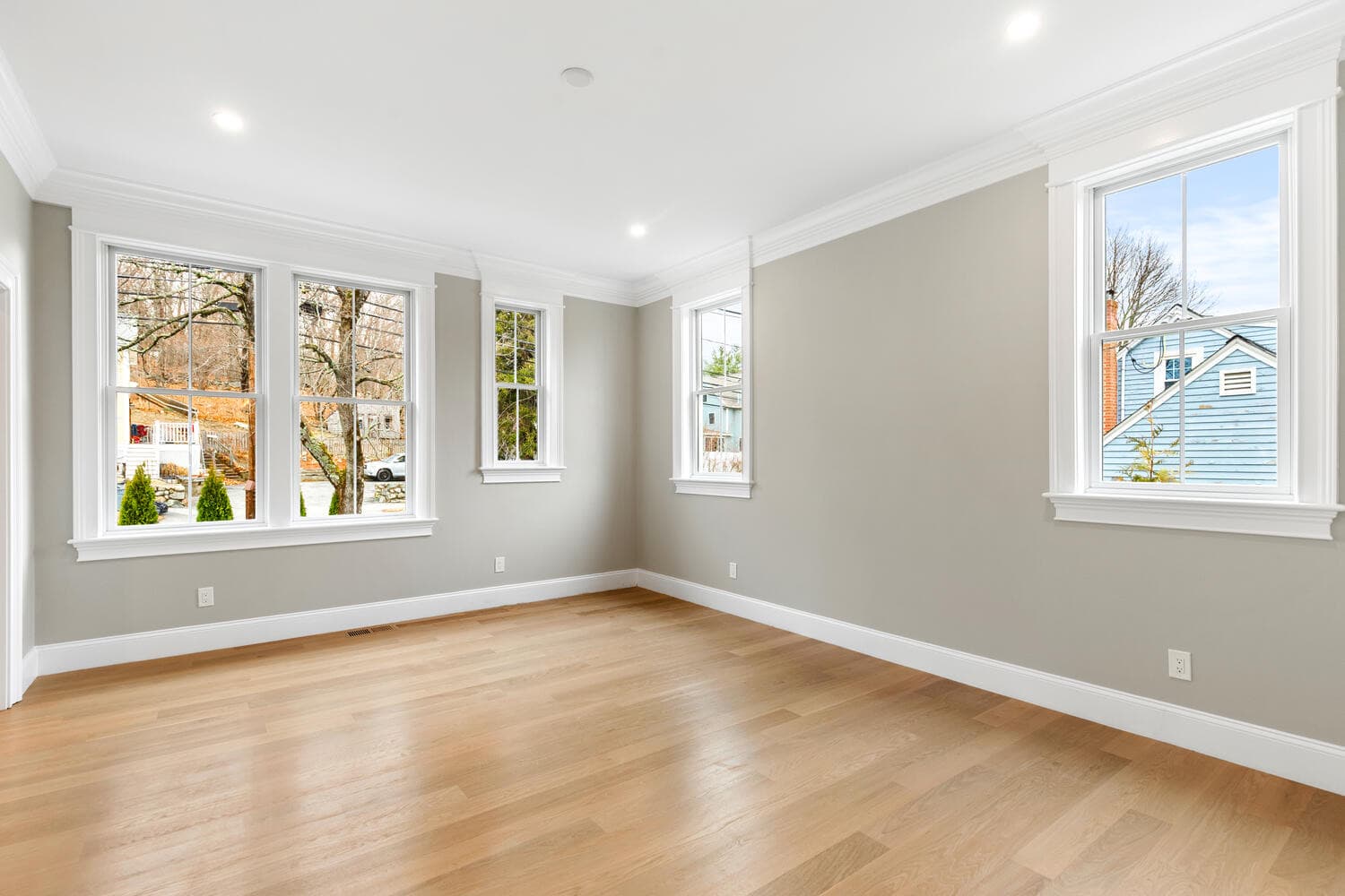 First floor bedroom with Andersen windows, white trim, and wainscoting