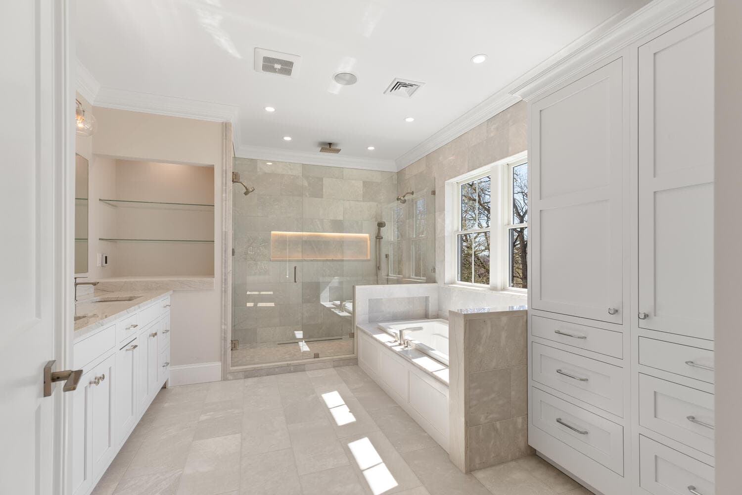 Primary bathroom with glass shower, soaking tub, and LED niche lighting