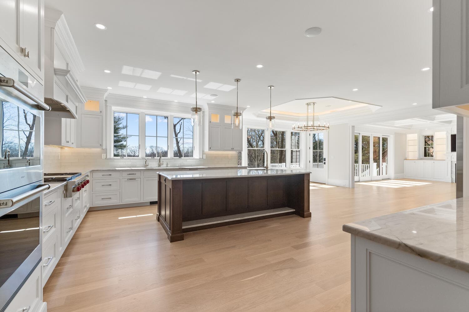Walk-in closet with crystal ring chandelier, vanity area, and custom built-ins