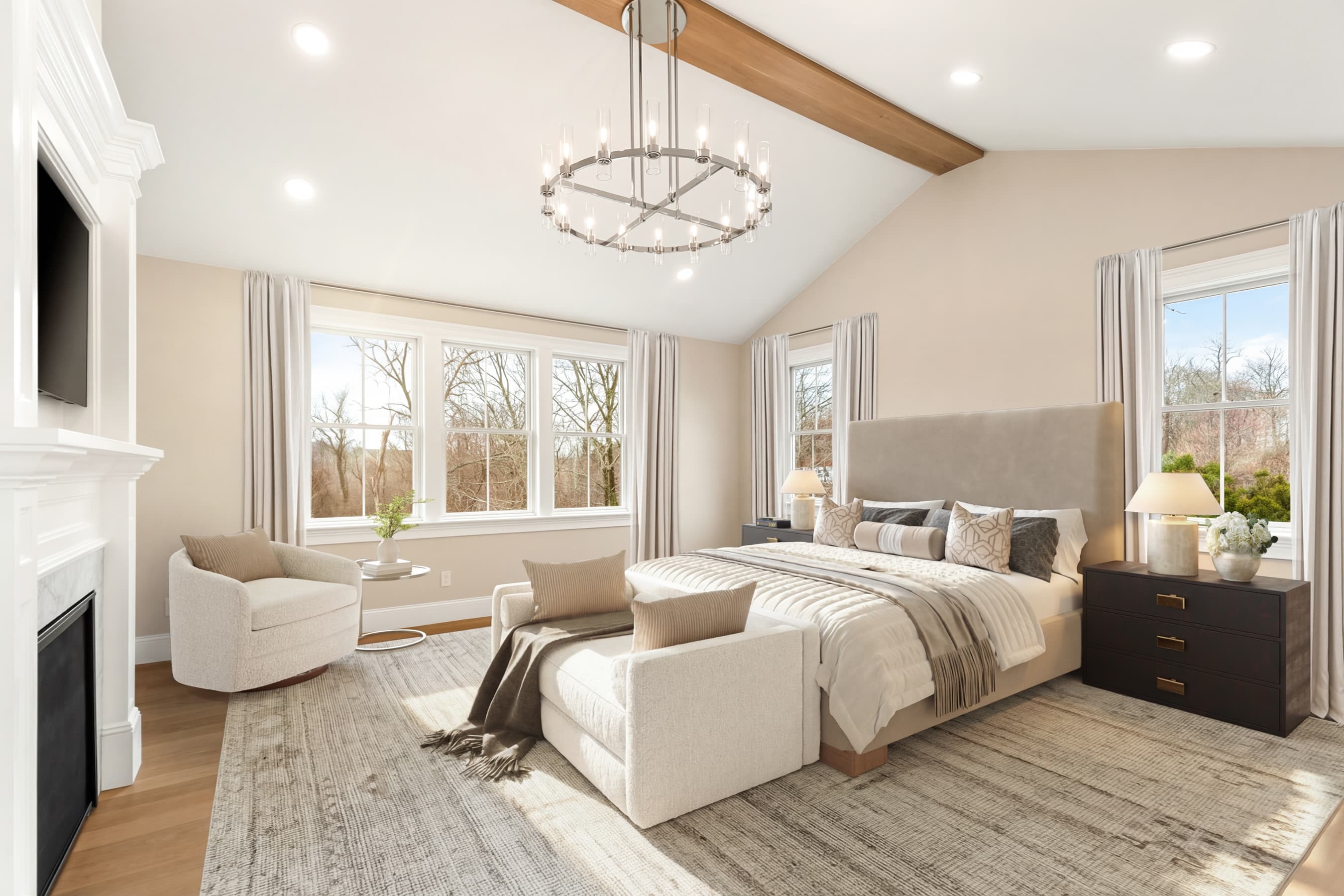 Primary bedroom with vaulted ceiling, wood beam, and sitting area — virtually staged
