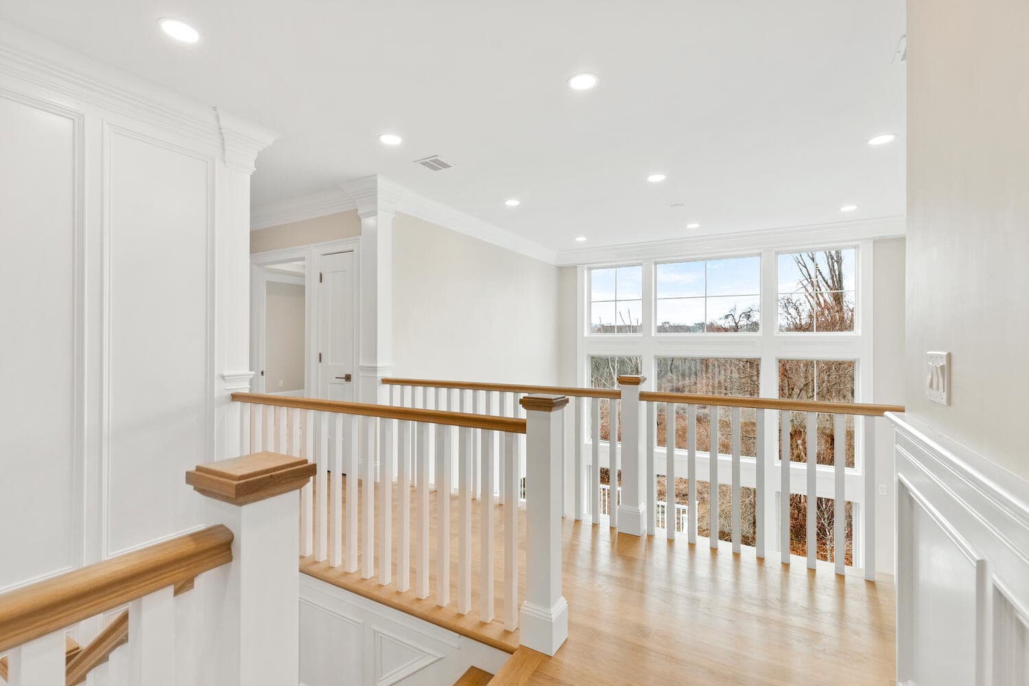 Upper foyer with dual vanity, marble counters, and glass shower